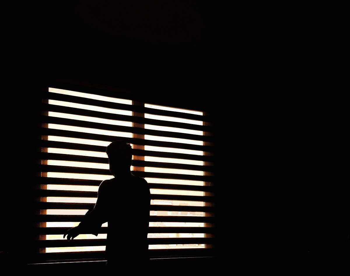 curtain man standing near window window